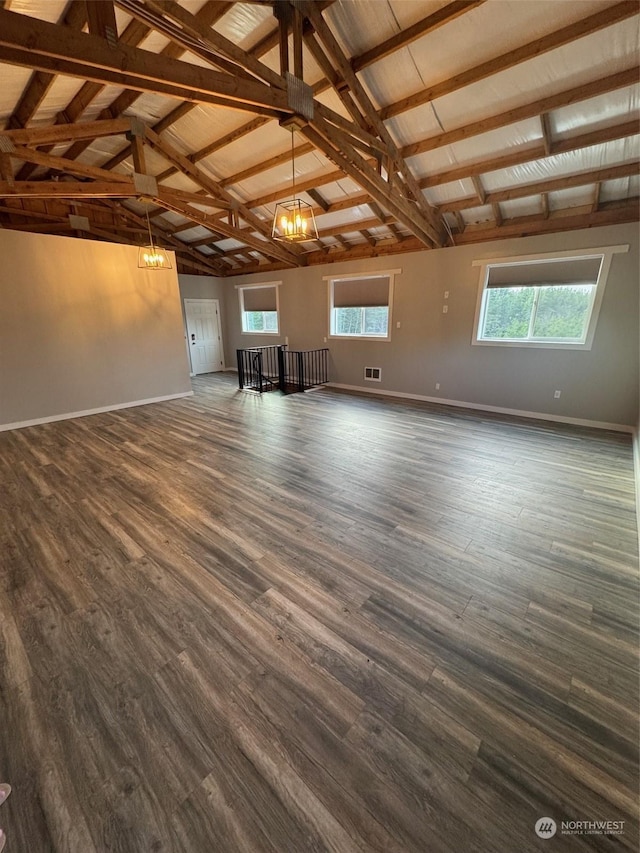 unfurnished living room with lofted ceiling with beams and dark wood-type flooring