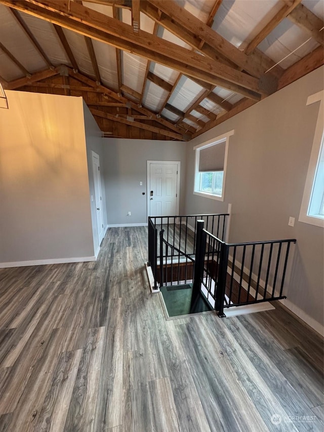 stairs featuring vaulted ceiling with beams, wooden ceiling, and wood-type flooring