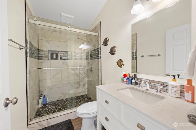 bathroom with vanity, wood-type flooring, an enclosed shower, and toilet