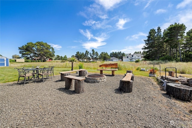 view of yard with a fire pit