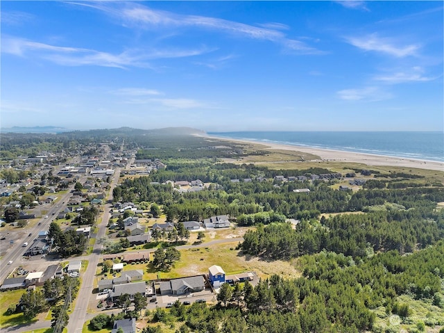 bird's eye view featuring a water view and a beach view