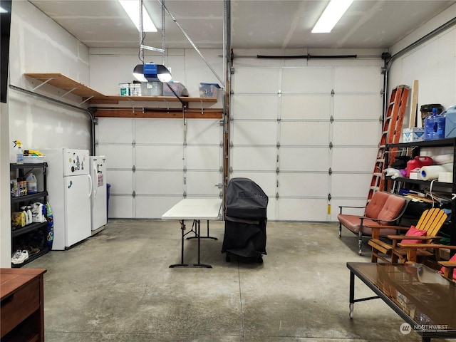 garage with white fridge and a garage door opener