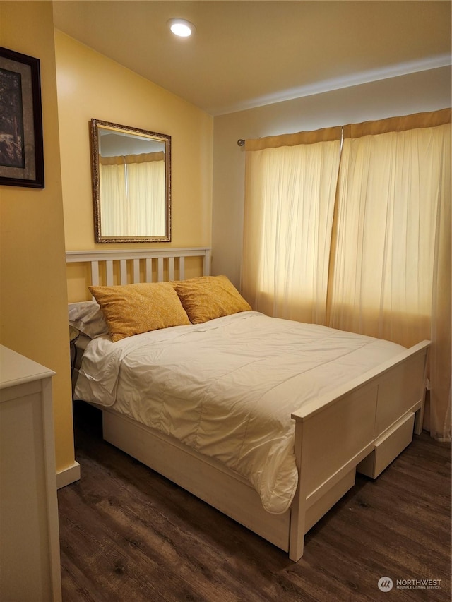 bedroom with dark hardwood / wood-style flooring