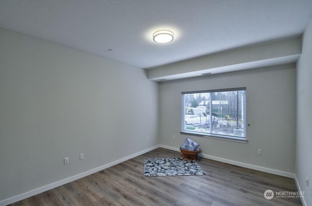 spare room with hardwood / wood-style floors