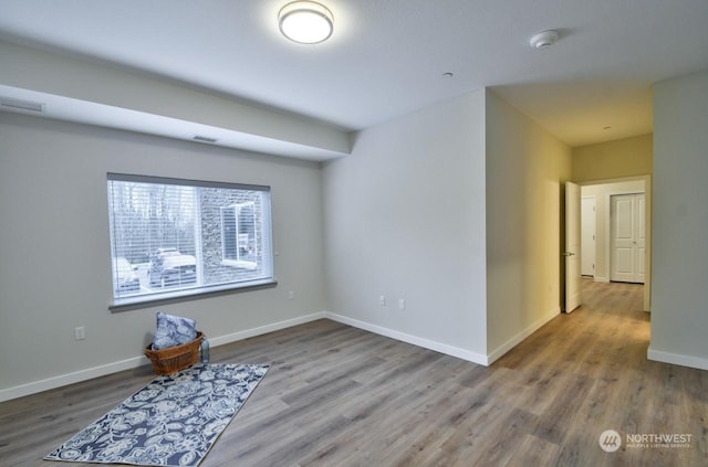 unfurnished room with hardwood / wood-style flooring