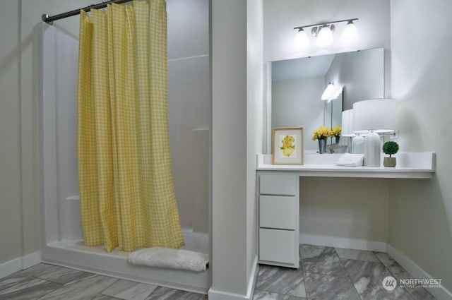 bathroom featuring vanity and a shower with shower curtain