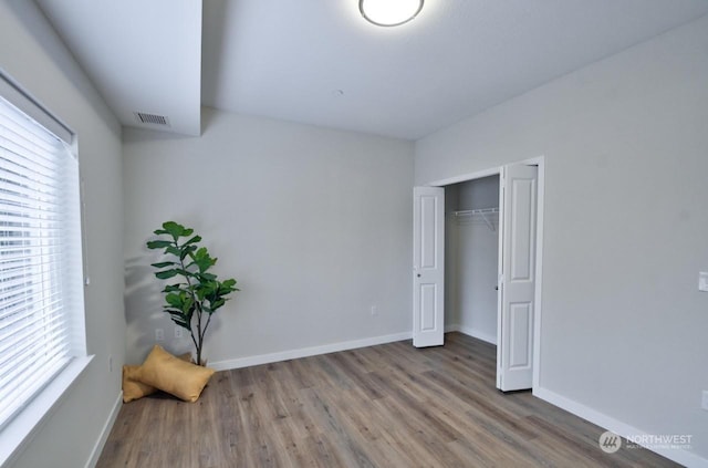 bedroom featuring hardwood / wood-style flooring and a closet