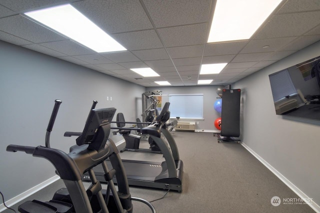 workout area with a drop ceiling and carpet floors