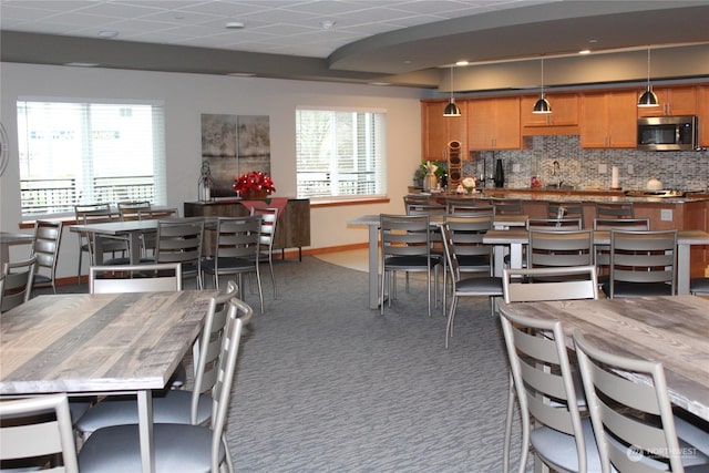 dining room featuring dark colored carpet