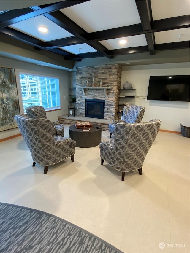 living room with coffered ceiling, beam ceiling, and a fireplace