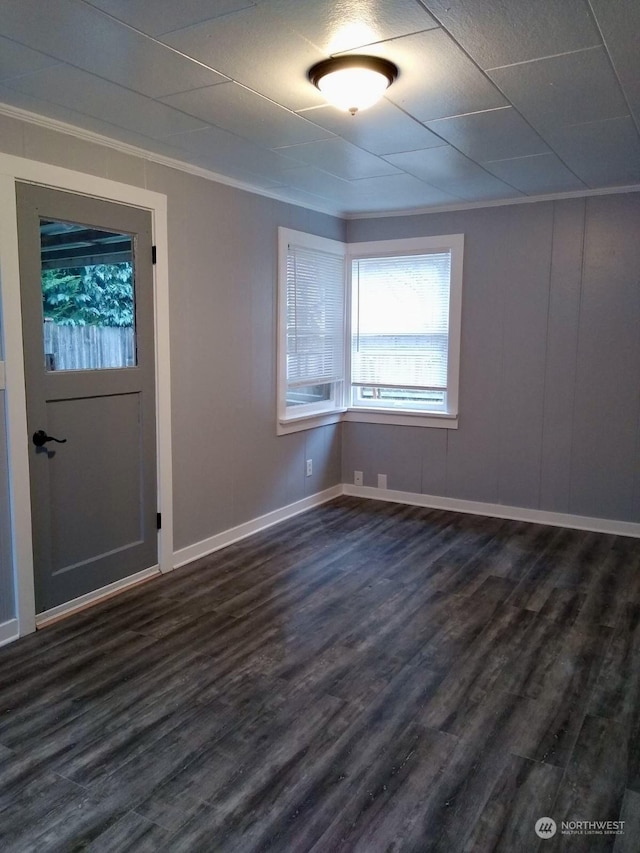 entryway with dark wood-type flooring and ornamental molding