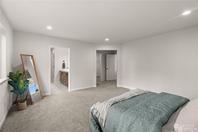 carpeted bedroom featuring ensuite bathroom