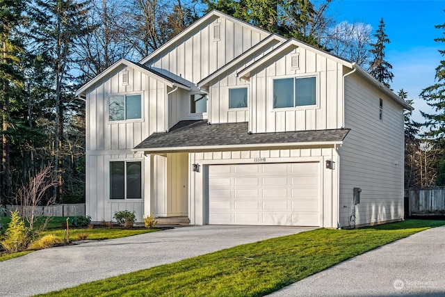 view of front of property featuring a garage and a front lawn