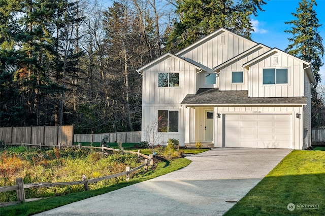 modern inspired farmhouse featuring a front yard and a garage