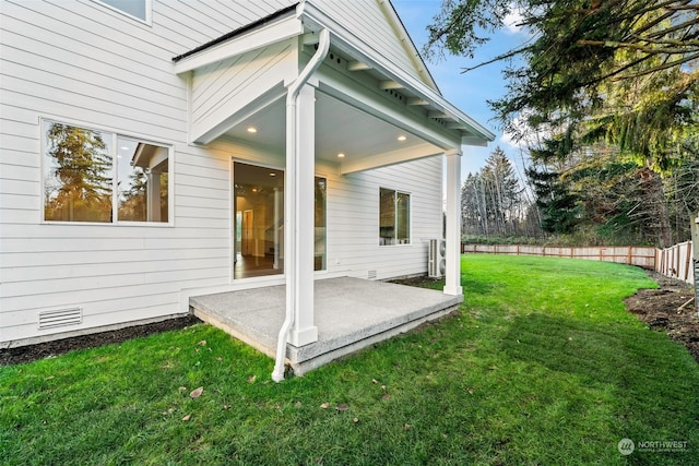 rear view of property featuring a yard and a patio