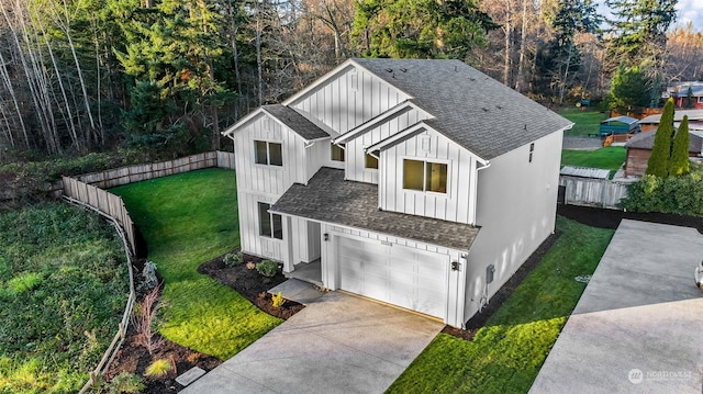 modern farmhouse featuring a front yard and a garage