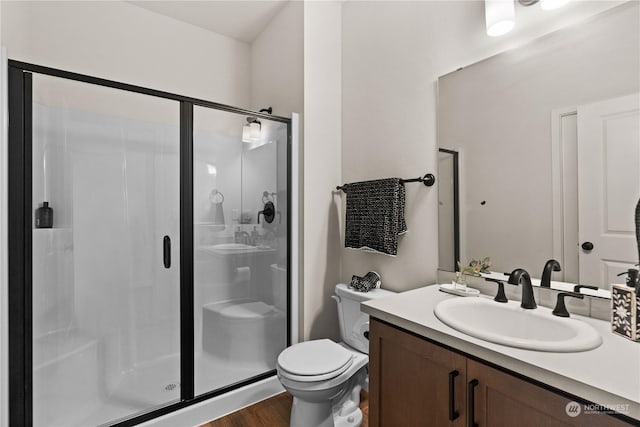 bathroom featuring hardwood / wood-style floors, vanity, toilet, and an enclosed shower