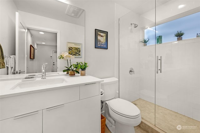 bathroom with vanity, an enclosed shower, and toilet