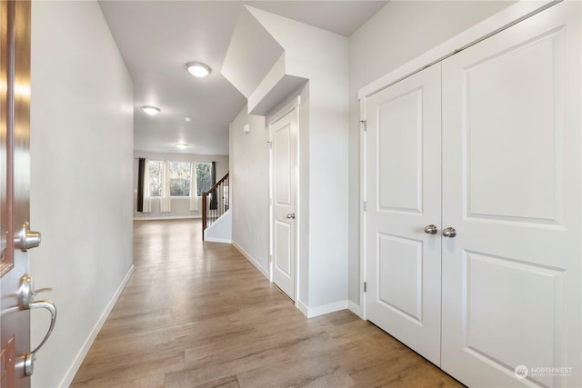 hallway with light wood-type flooring