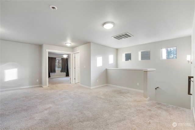 unfurnished room with light colored carpet