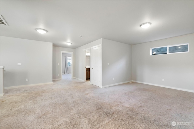 unfurnished room with light colored carpet