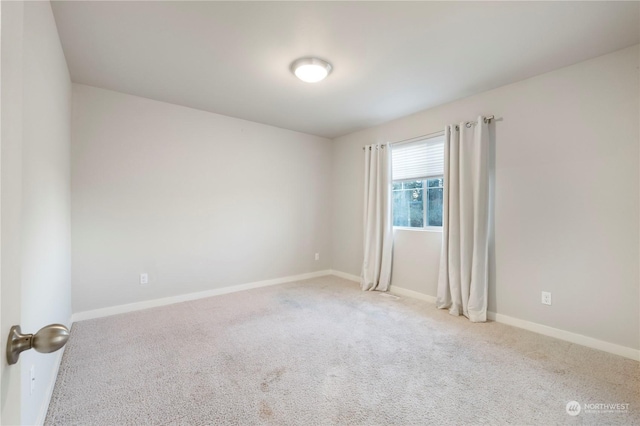 empty room featuring light carpet