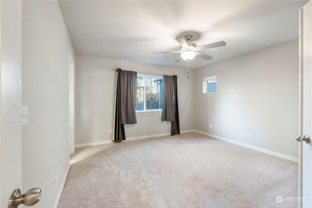 spare room with light colored carpet and ceiling fan