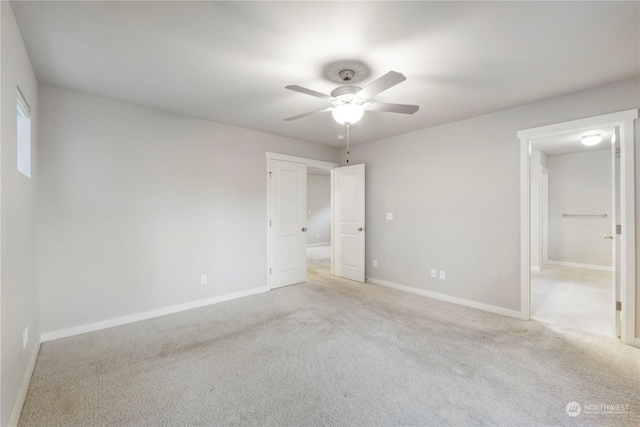 unfurnished room featuring ceiling fan and light carpet