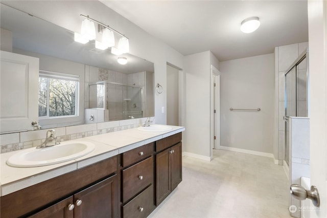 bathroom with a shower with door and vanity