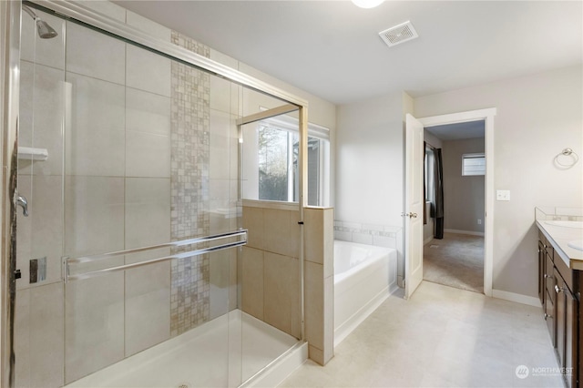 bathroom with shower with separate bathtub and vanity