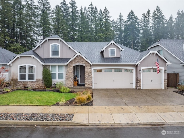 craftsman inspired home featuring a front yard and a garage