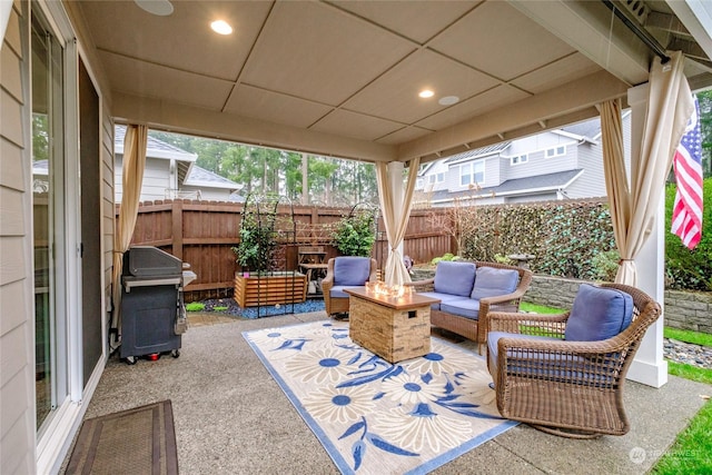 view of patio featuring area for grilling and an outdoor living space with a fire pit