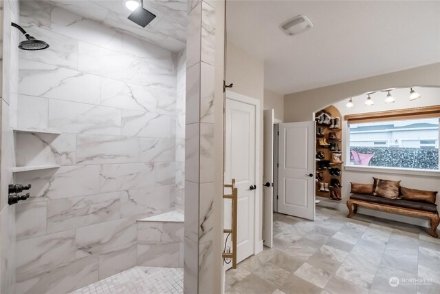 bathroom with a tile shower