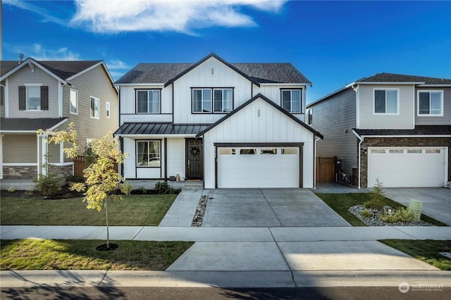 view of front of home with a front yard and a garage