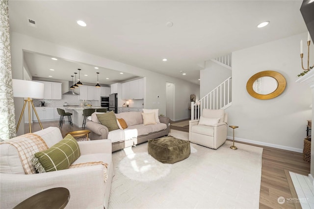 living room with light hardwood / wood-style flooring