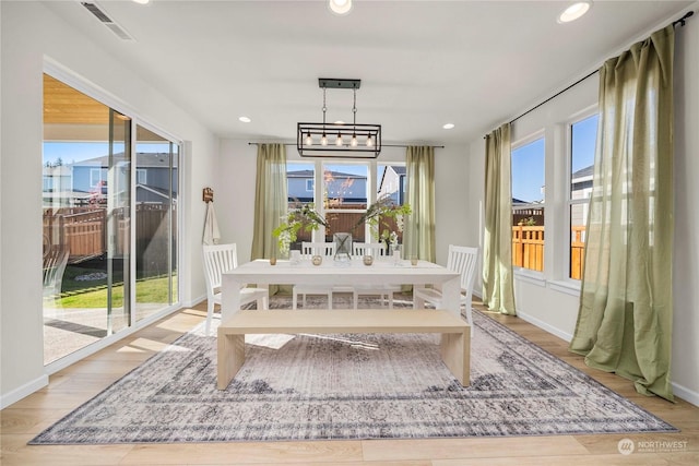 dining space featuring a chandelier and light hardwood / wood-style floors