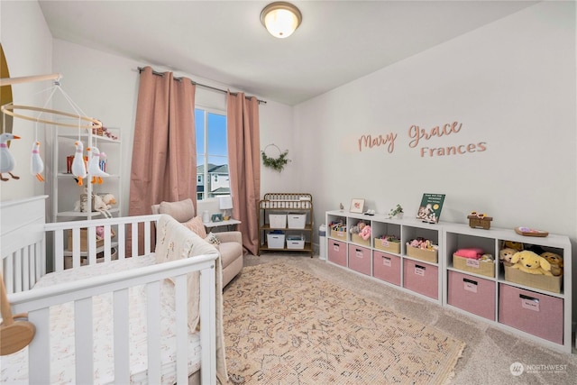 bedroom with carpet flooring and a nursery area