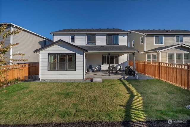 back of house featuring a yard and a patio area