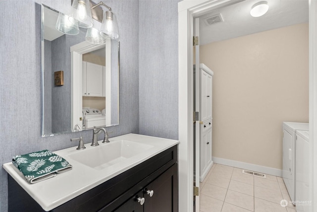 bathroom featuring tile patterned floors, vanity, toilet, and independent washer and dryer