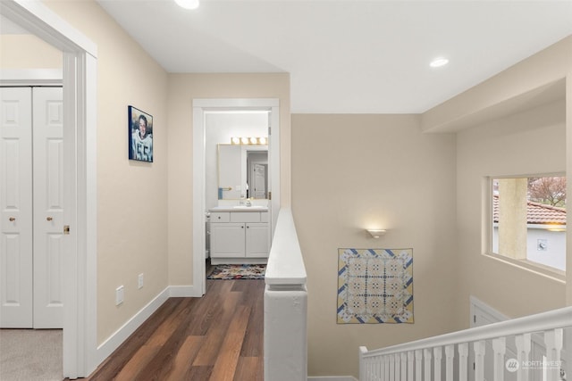 hallway featuring sink and dark hardwood / wood-style floors