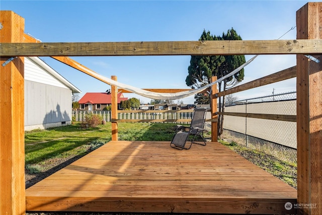 wooden deck featuring a yard