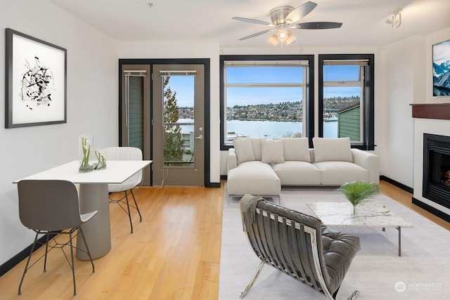 living room featuring light wood-type flooring and ceiling fan