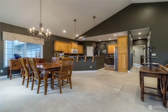 dining area featuring high vaulted ceiling, light colored carpet, and a notable chandelier