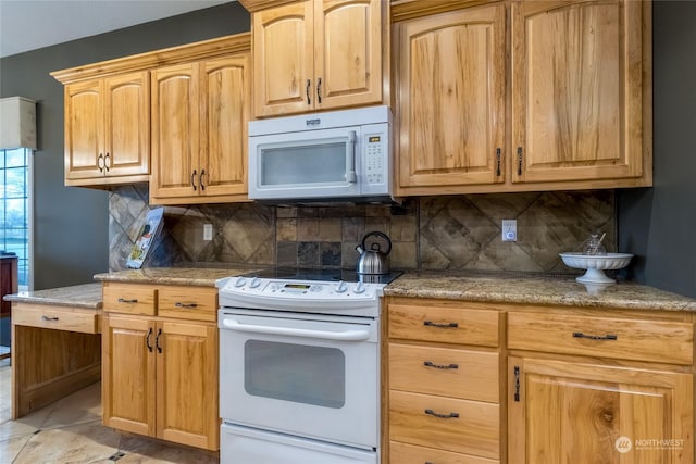 kitchen with light tile patterned floors, white appliances, and tasteful backsplash