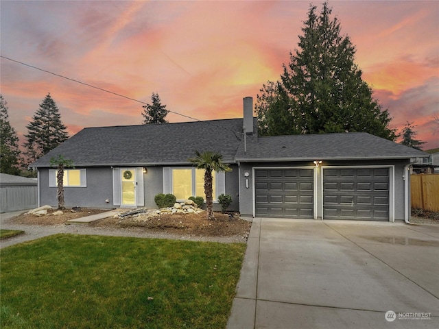 single story home featuring a yard and a garage