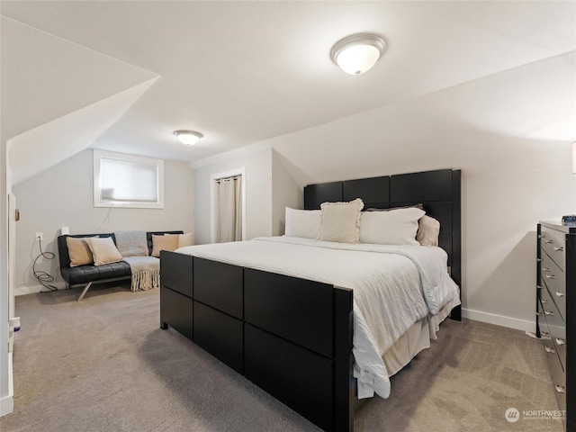 carpeted bedroom featuring lofted ceiling