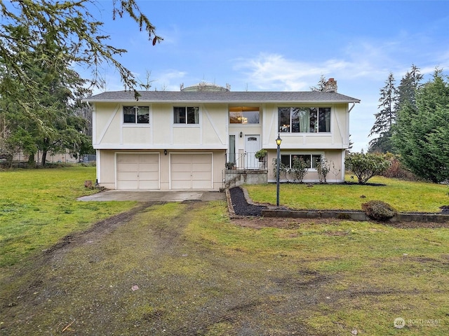 split foyer home featuring a front yard and a garage