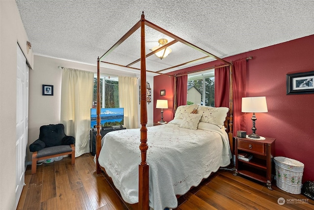 bedroom featuring hardwood / wood-style flooring and a textured ceiling