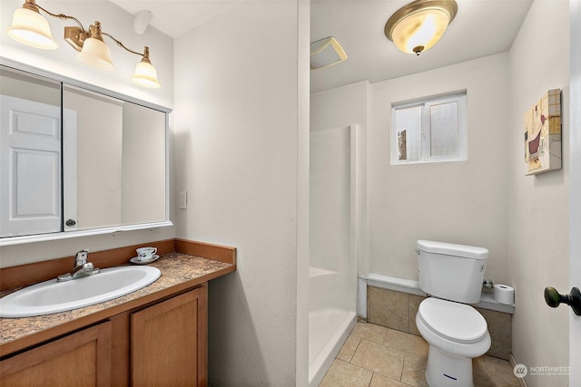 bathroom featuring tile patterned floors, vanity, toilet, and walk in shower