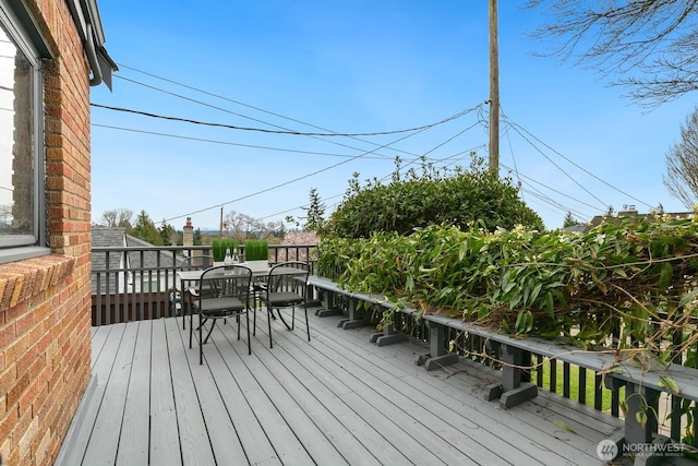 wooden terrace with outdoor dining space